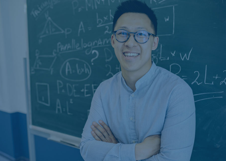 Faculty by a blackboard